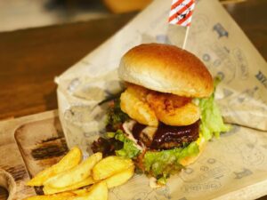 京都駅近くにある肉カフェ「NICK STOCK イオンモールKYOTO店」で提供しているぷりぷりのエビをハンバーガーにした『シュリンプ熟成牛バーガー』の写真